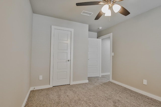 unfurnished bedroom featuring light colored carpet and ceiling fan