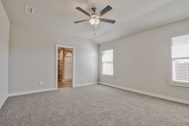 unfurnished room featuring lofted ceiling, ceiling fan, and carpet