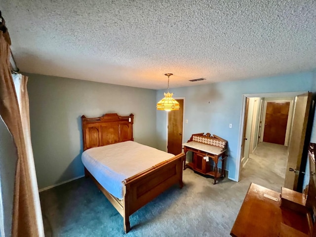 carpeted bedroom featuring a textured ceiling