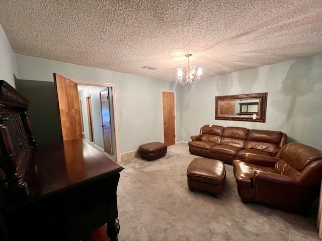 living room with a textured ceiling, carpet floors, and a chandelier