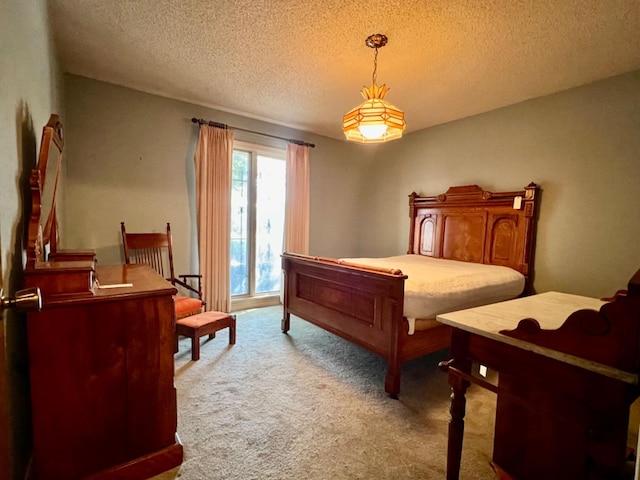 bedroom with light carpet, access to exterior, and a textured ceiling