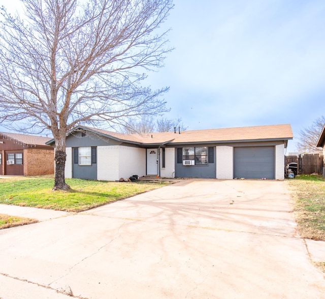 ranch-style home with a garage and a front yard