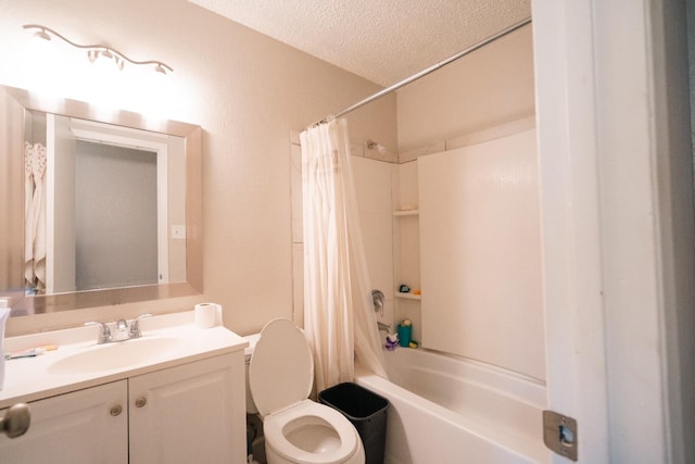 full bathroom with toilet, vanity, a textured ceiling, and shower / bath combo with shower curtain