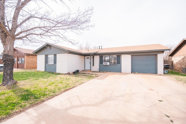 ranch-style house with central AC, a garage, and a front lawn