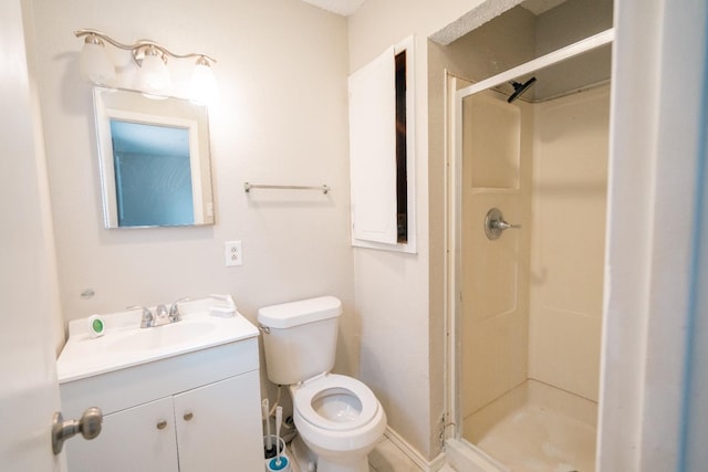 bathroom featuring walk in shower, vanity, and toilet