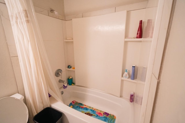 bathroom with toilet and shower / bath combo