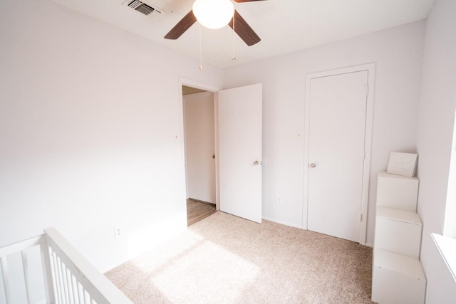 unfurnished bedroom with light carpet and ceiling fan