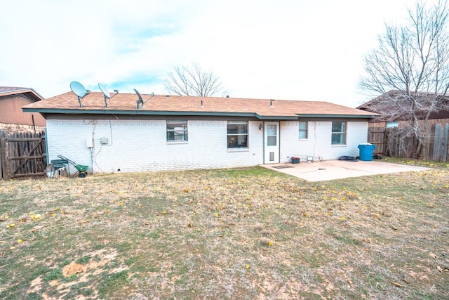 rear view of property with a patio area and a lawn