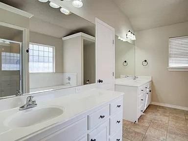 bathroom featuring vanity, tile patterned flooring, and separate shower and tub