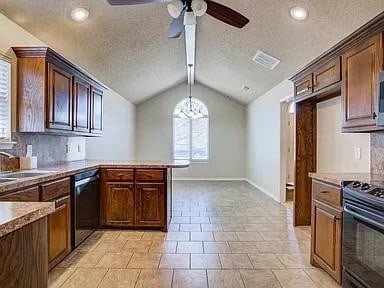 kitchen featuring lofted ceiling, dishwasher, kitchen peninsula, range with electric cooktop, and backsplash