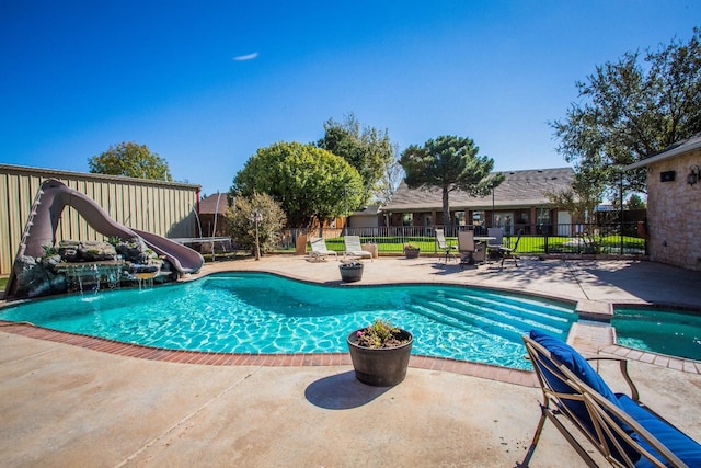 view of pool featuring a patio and a water slide