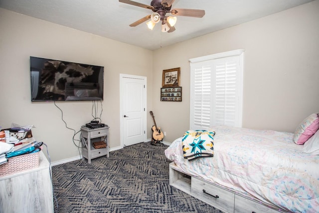 bedroom with ceiling fan and dark colored carpet