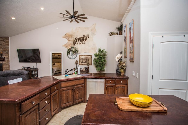 kitchen featuring sink, light tile patterned floors, dishwasher, a center island with sink, and vaulted ceiling