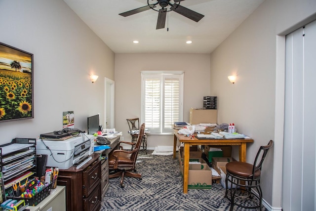 carpeted office space featuring ceiling fan