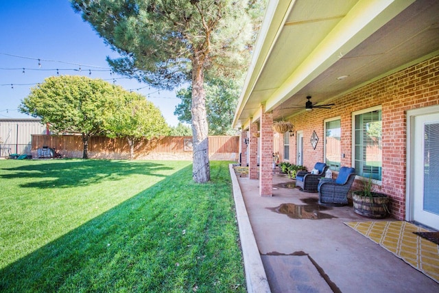 view of yard with a patio area and ceiling fan