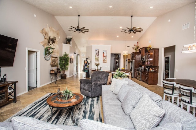 living room with high vaulted ceiling and ceiling fan