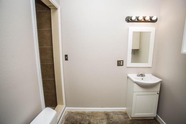 bathroom featuring a shower and vanity