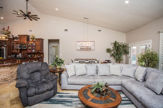 living room featuring high vaulted ceiling and ceiling fan