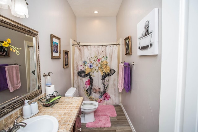 bathroom featuring a shower with shower curtain, vanity, toilet, and hardwood / wood-style floors