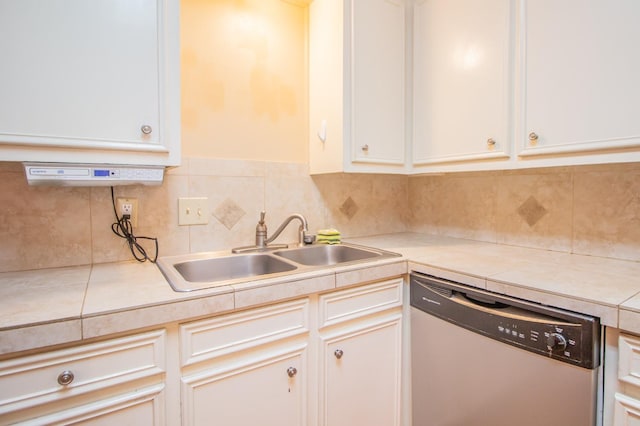 kitchen featuring white cabinetry, stainless steel dishwasher, sink, and decorative backsplash