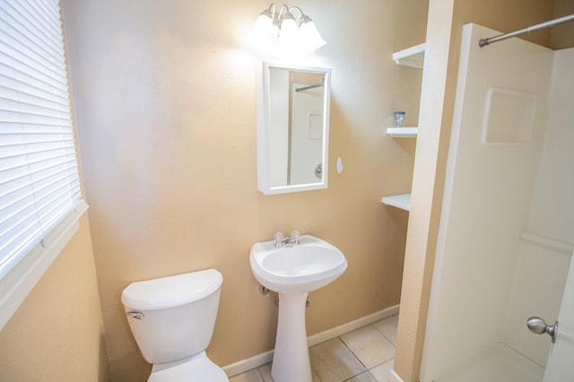 bathroom featuring toilet, tile patterned floors, and walk in shower