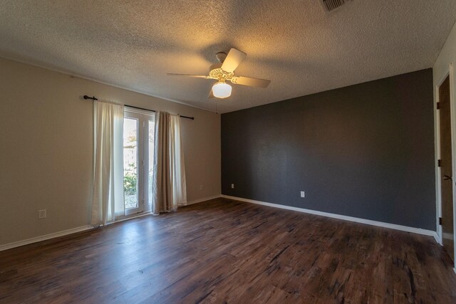 empty room featuring a textured ceiling, dark hardwood / wood-style floors, and ceiling fan