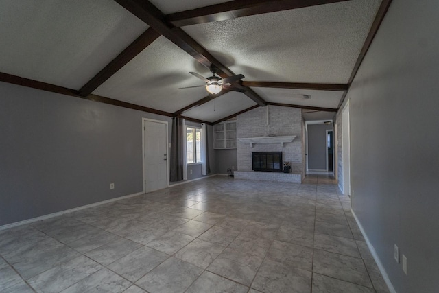 unfurnished living room with ceiling fan, a brick fireplace, vaulted ceiling with beams, and a textured ceiling