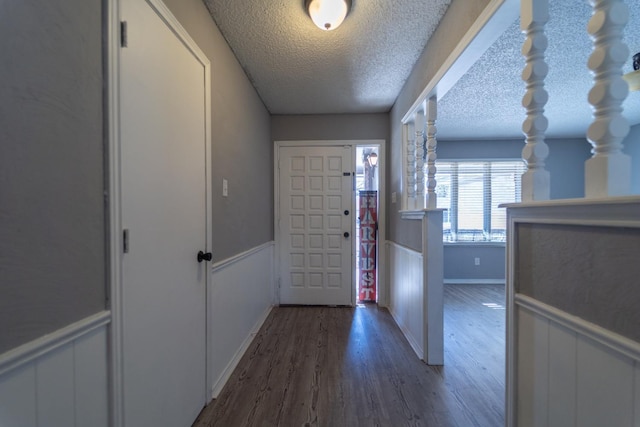 foyer entrance featuring dark wood-type flooring and a textured ceiling