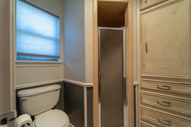 bathroom featuring walk in shower and toilet