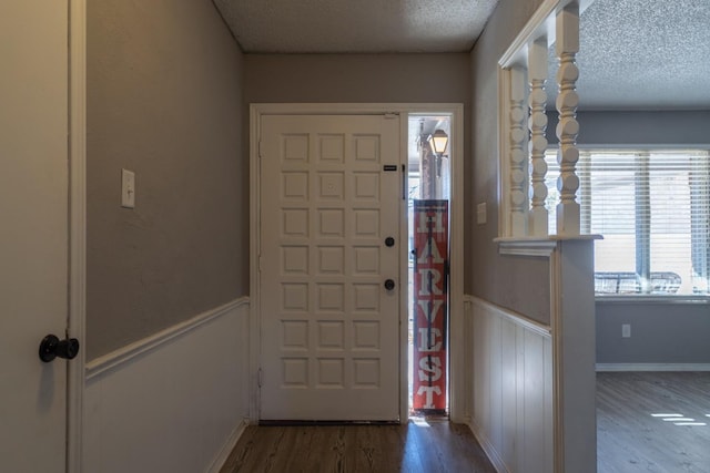 entryway with hardwood / wood-style floors and a textured ceiling