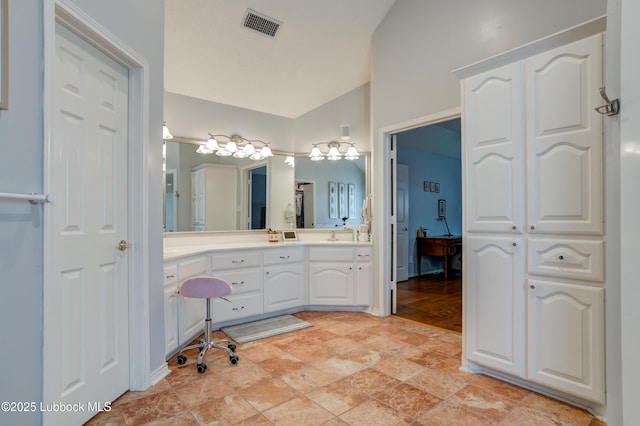 4801 Amherst St, Lubbock, TX 79416 - bathroom with vaulted ceiling, vanity, and stone finish floors