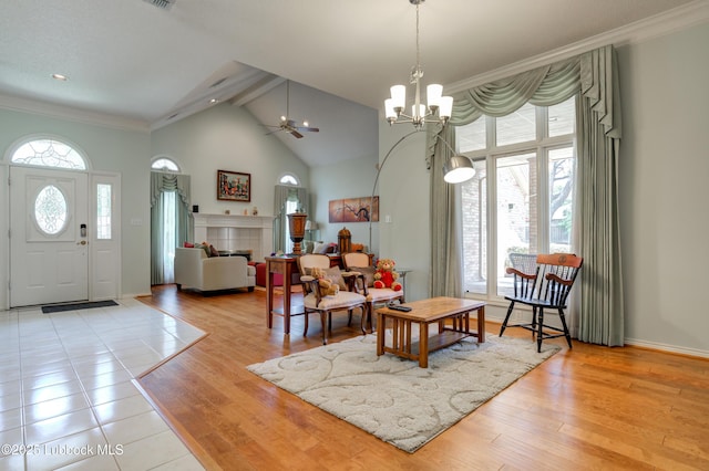 4801 Amherst St, Lubbock, TX 79416 - living room featuring ornamental molding, a chandelier, high vaulted ceiling, wood finished floors, and ceiling fan