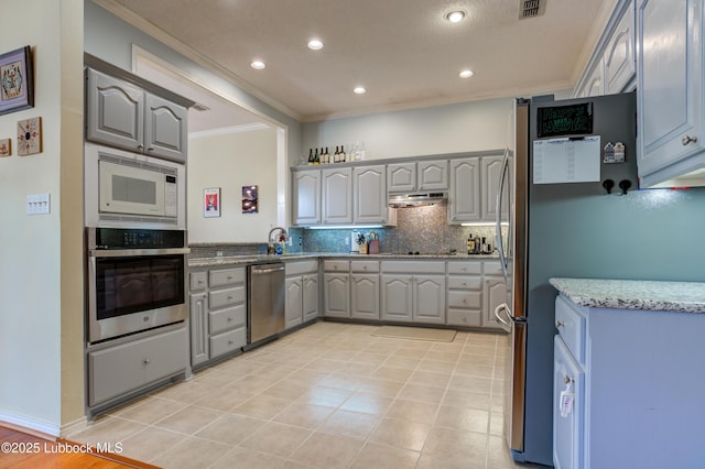 4801 Amherst St, Lubbock, TX 79416 - kitchen with stainless steel appliances, gray cabinetry, ornamental molding, backsplash, and under cabinet range hood
