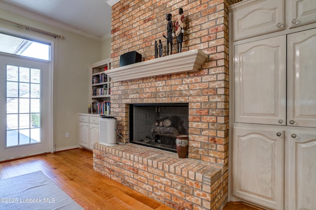 4801 Amherst St, Lubbock, TX 79416 - unfurnished living room featuring light wood-style floors, ornamental molding, and a brick fireplace