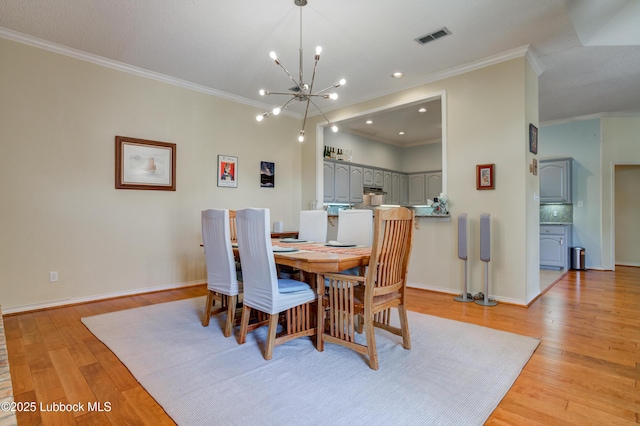 4801 Amherst St, Lubbock, TX 79416 - dining space featuring a chandelier, crown molding, and light wood-type flooring