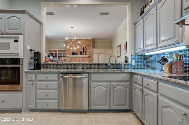 4801 Amherst St, Lubbock, TX 79416 - kitchen with appliances with stainless steel finishes, tasteful backsplash, crown molding, light stone countertops, and gray cabinetry
