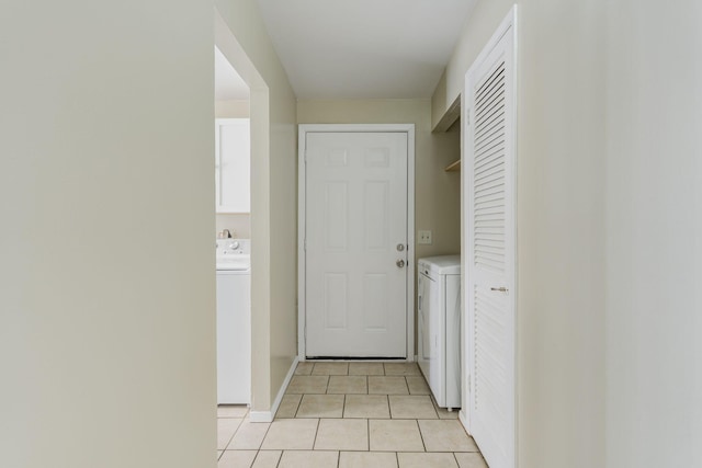 laundry room with light tile patterned floors and washer / dryer