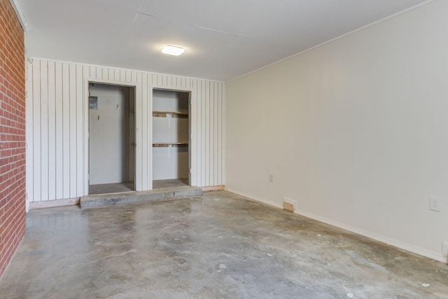 unfurnished bedroom featuring concrete flooring