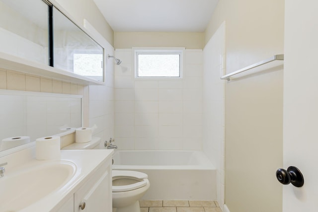 full bathroom with vanity, tiled shower / bath combo, tile patterned floors, and toilet