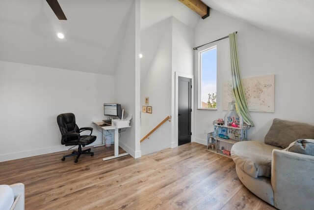 interior space featuring lofted ceiling with beams and light hardwood / wood-style flooring