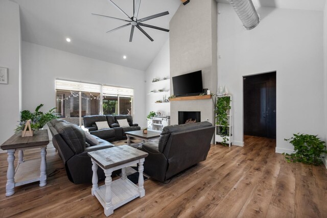 living room with hardwood / wood-style floors and high vaulted ceiling