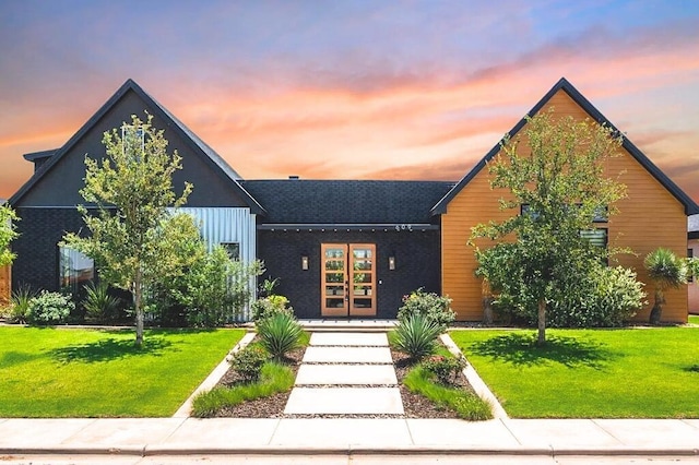 view of front of house featuring french doors and a front lawn