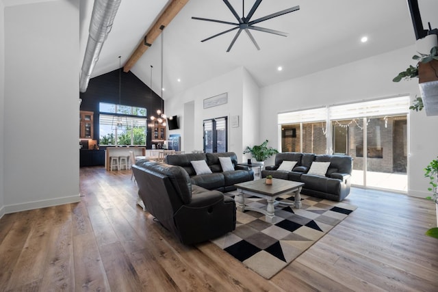 living room featuring hardwood / wood-style floors, beam ceiling, and high vaulted ceiling