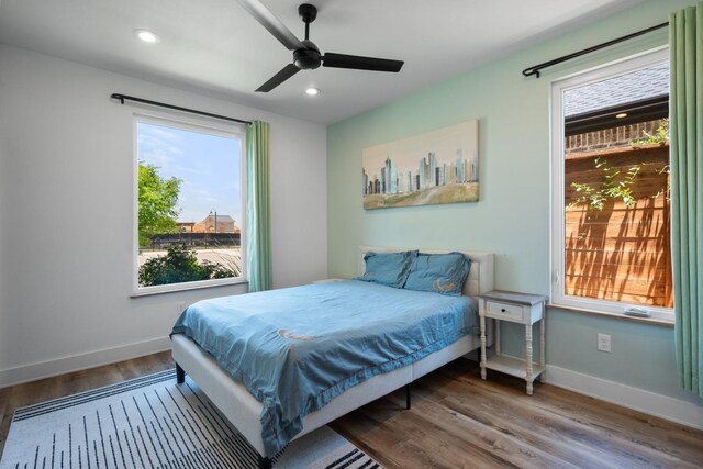 bedroom with recessed lighting, wood finished floors, and baseboards