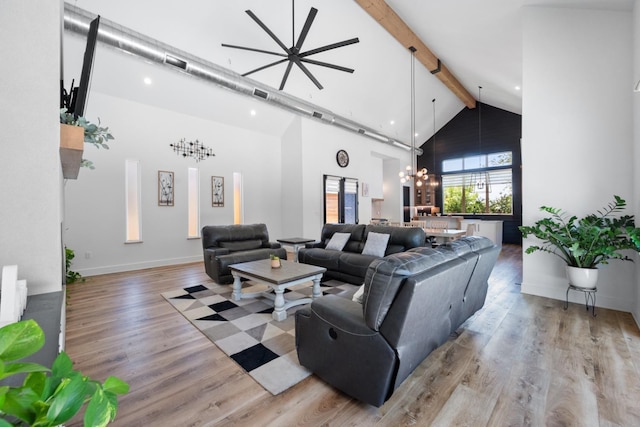 living room featuring beamed ceiling, light hardwood / wood-style floors, high vaulted ceiling, and a notable chandelier