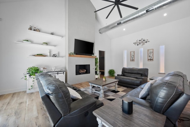 living room with light wood-type flooring and a high ceiling