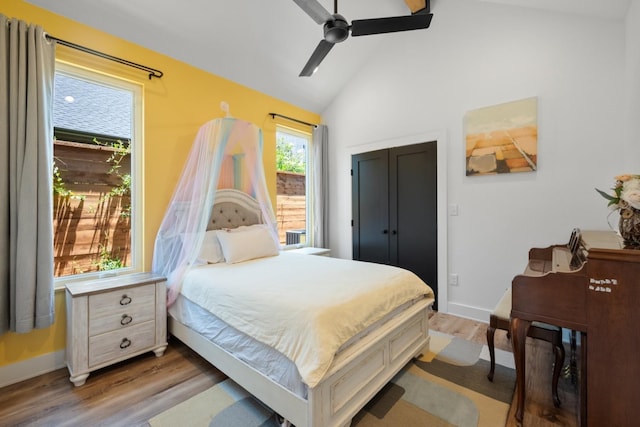 bedroom with lofted ceiling, ceiling fan, and light wood-type flooring