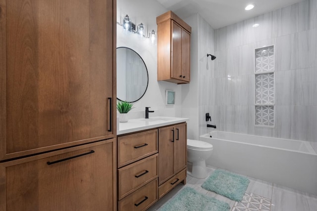 full bathroom featuring vanity, tile patterned floors, toilet, and tiled shower / bath