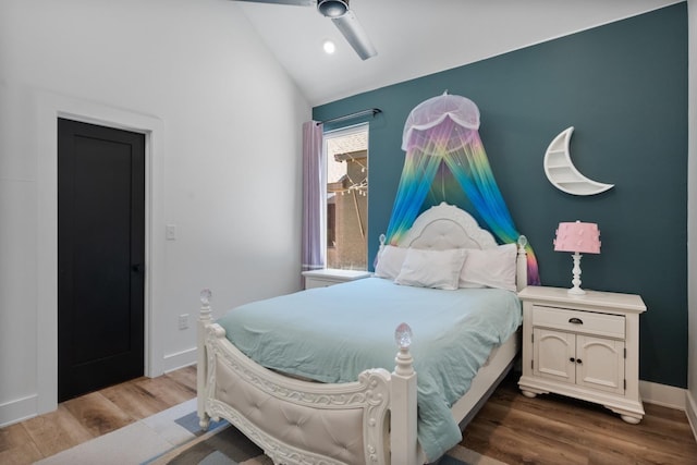 bedroom with lofted ceiling, hardwood / wood-style flooring, and ceiling fan