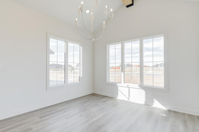 unfurnished dining area featuring lofted ceiling with beams, plenty of natural light, an inviting chandelier, and light hardwood / wood-style flooring